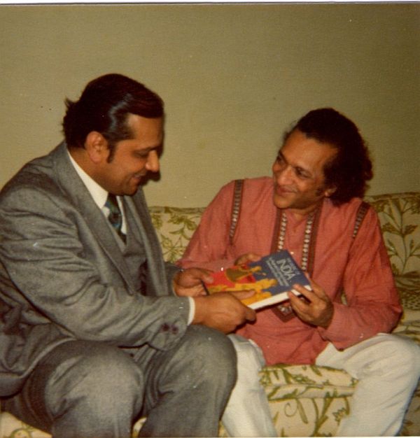 Reginald Massey, left, presenting his book to Ravi Shankar