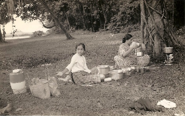 Purnima with her mother in Entebbe. There is a kerosene stove under the tree.