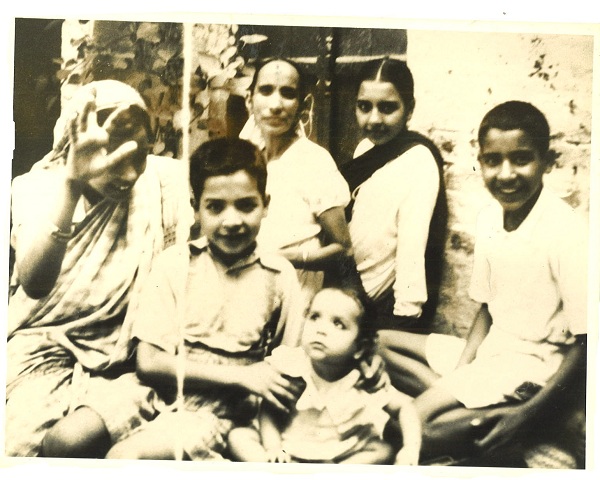 Front: Jatinder (6 years old) holding first child, Shashi, of his older sister, Prem Behnji (back left). Others at back: my mother, my sister Santosh, and my younger brother, Satinder.