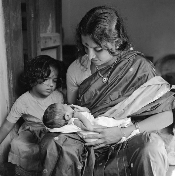 Meenakshi with Vasanti (on lap), 11 days old. Kalyani, 3 years old, look on. (Pondicherry)